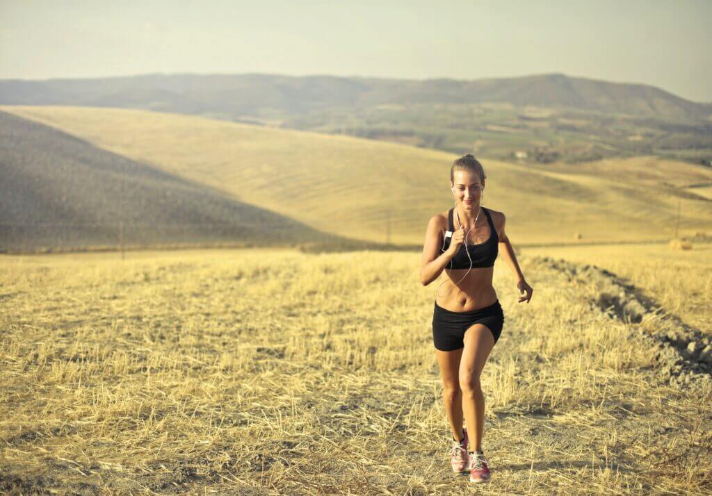 Woman running on trails while listening to music
