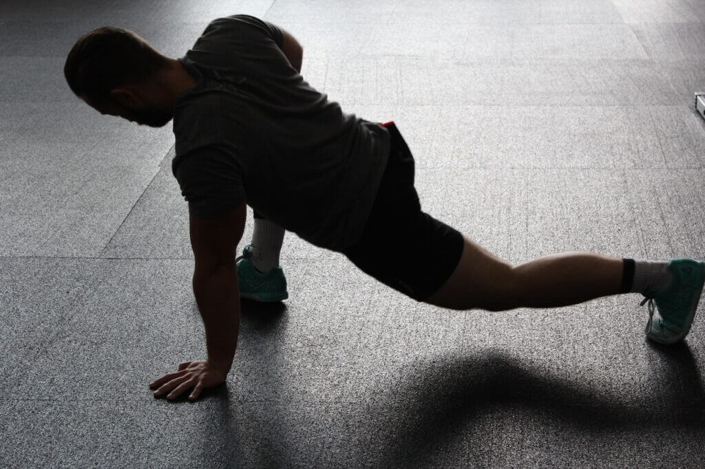 A man doing stretches to correct his hip drop running