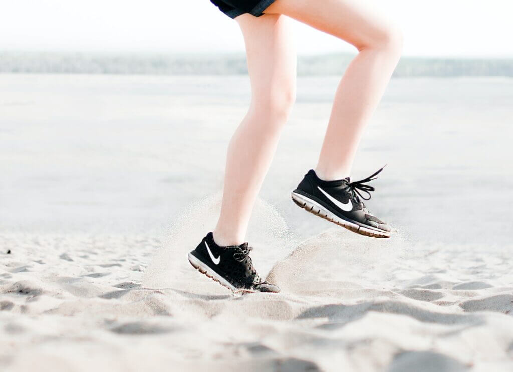 Legs of someone running on sand