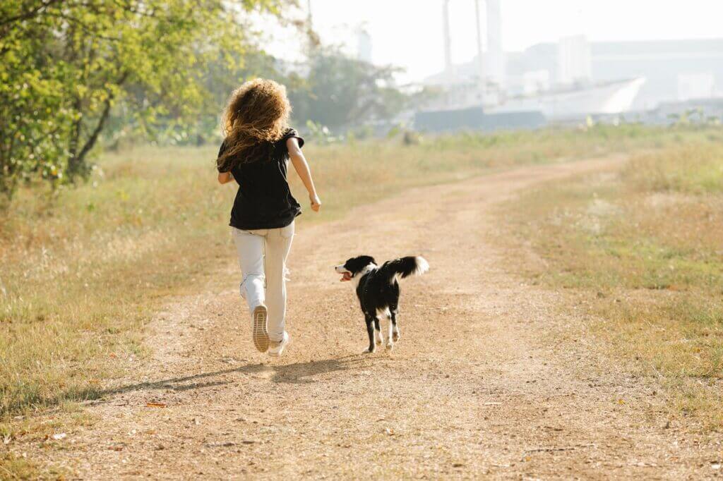 Woman running outside with her dog