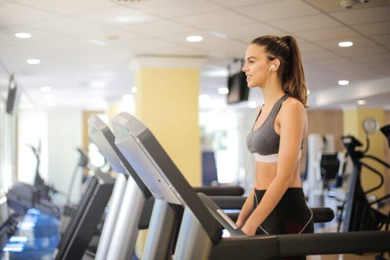Woman walking on a treadmill in a fitness studio