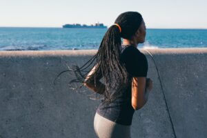 Photo of Woman Running Near Sea Wall